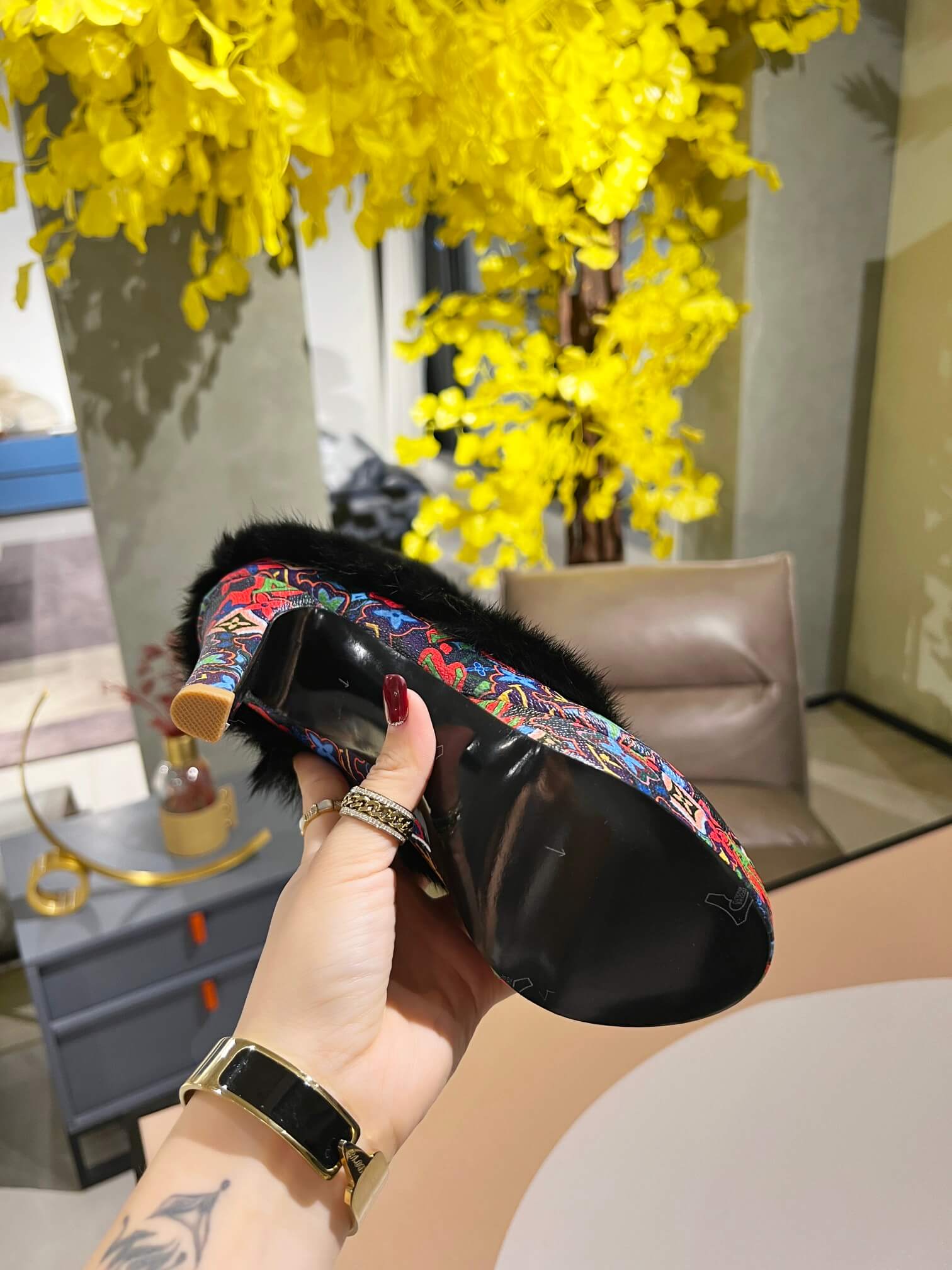 a pair of Louis Vuitton Winter Women Fluffy Faux Fox Fur Ankle Boots In multi-colored Monogram pattern