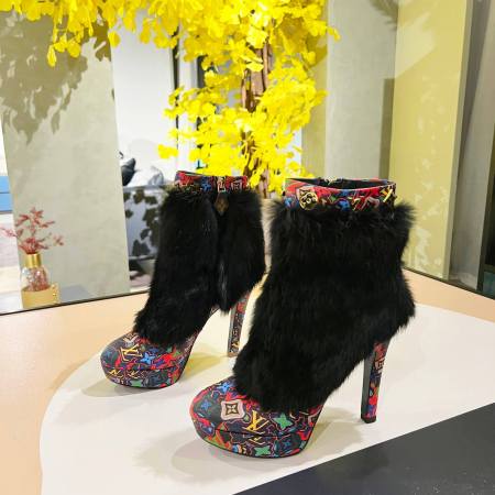 a pair of Louis Vuitton Winter Women Fluffy Faux Fox Fur Ankle Boots In multi-colored Monogram pattern
