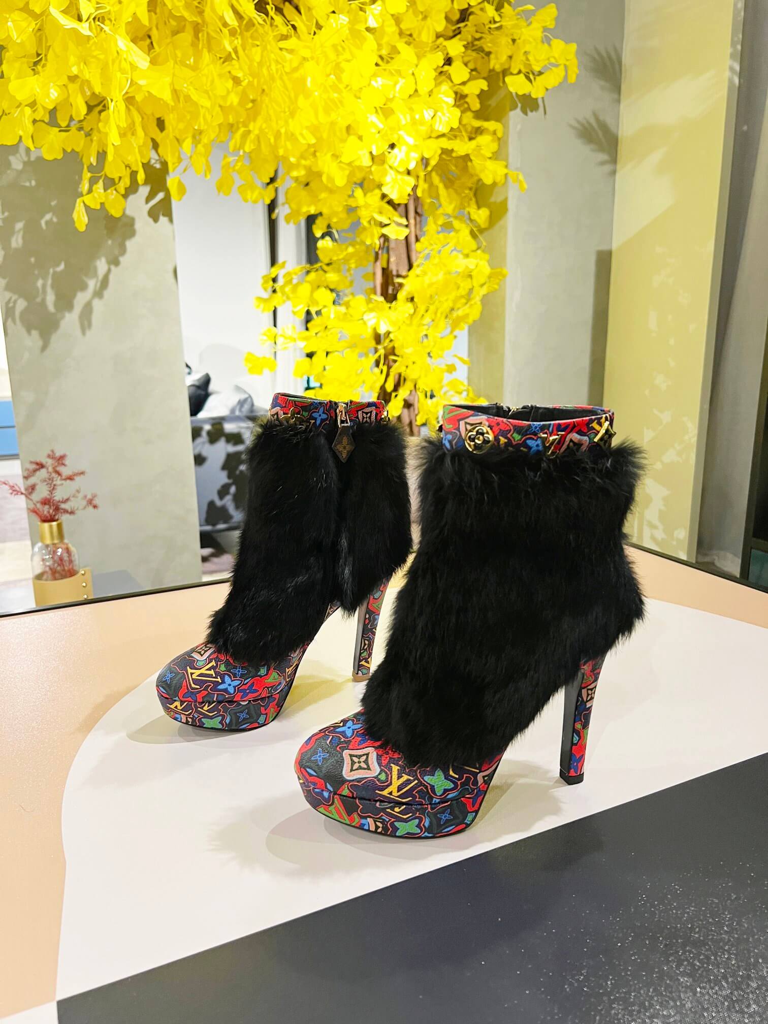 a pair of Louis Vuitton Winter Women Fluffy Faux Fox Fur Ankle Boots In multi-colored Monogram pattern