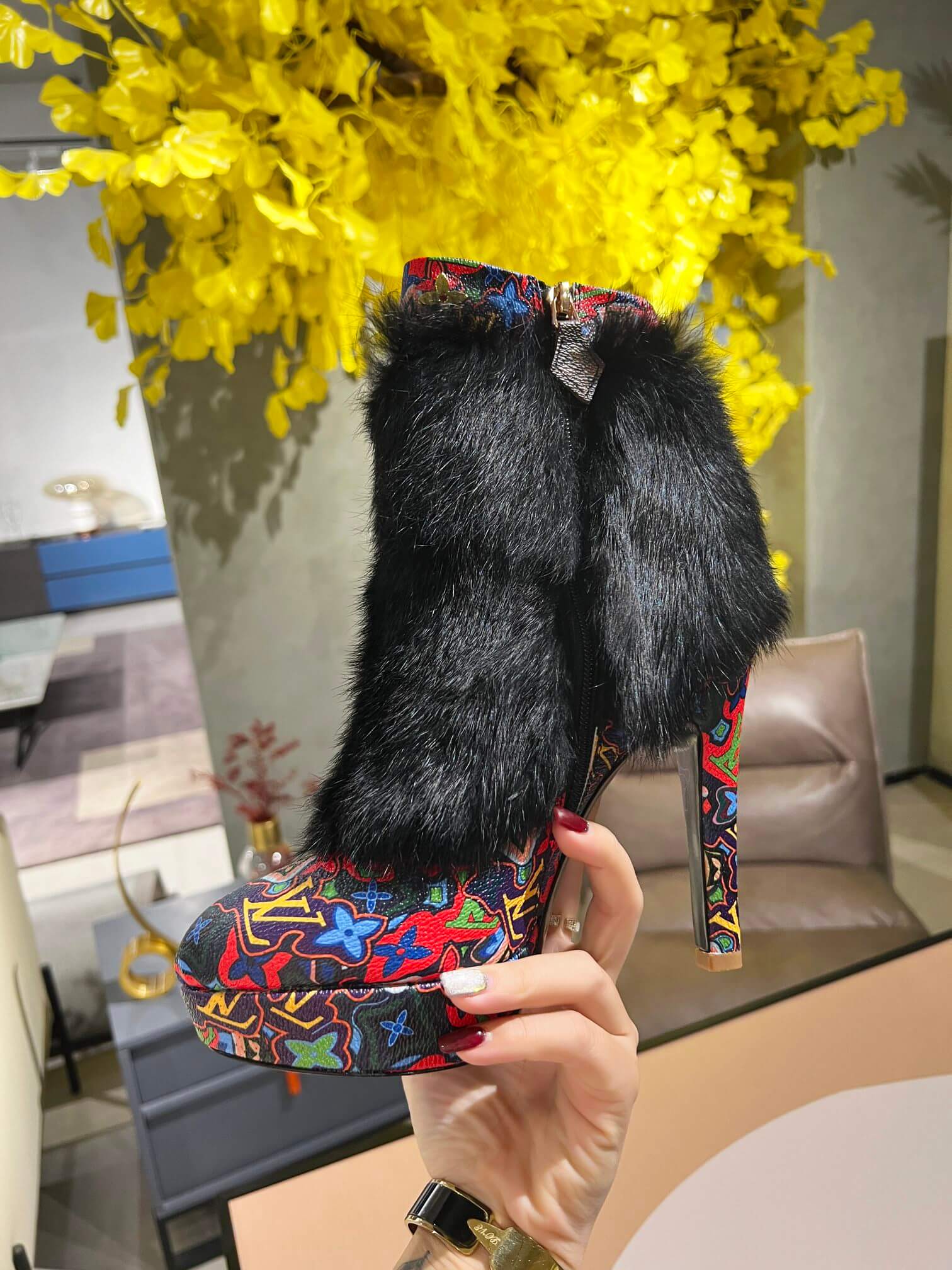 a pair of Louis Vuitton Winter Women Fluffy Faux Fox Fur Ankle Boots In multi-colored Monogram pattern