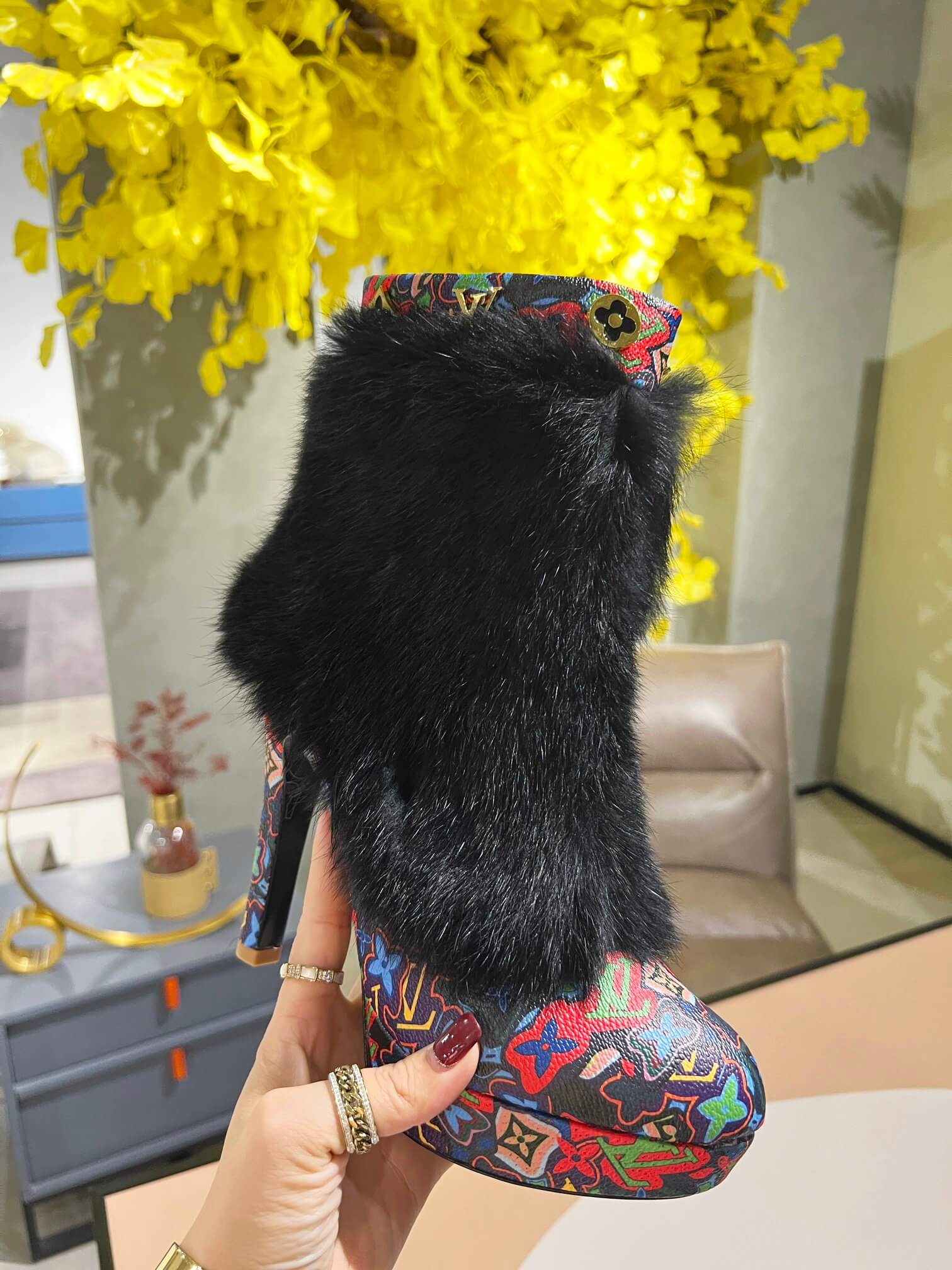 a pair of Louis Vuitton Winter Women Fluffy Faux Fox Fur Ankle Boots In multi-colored Monogram pattern