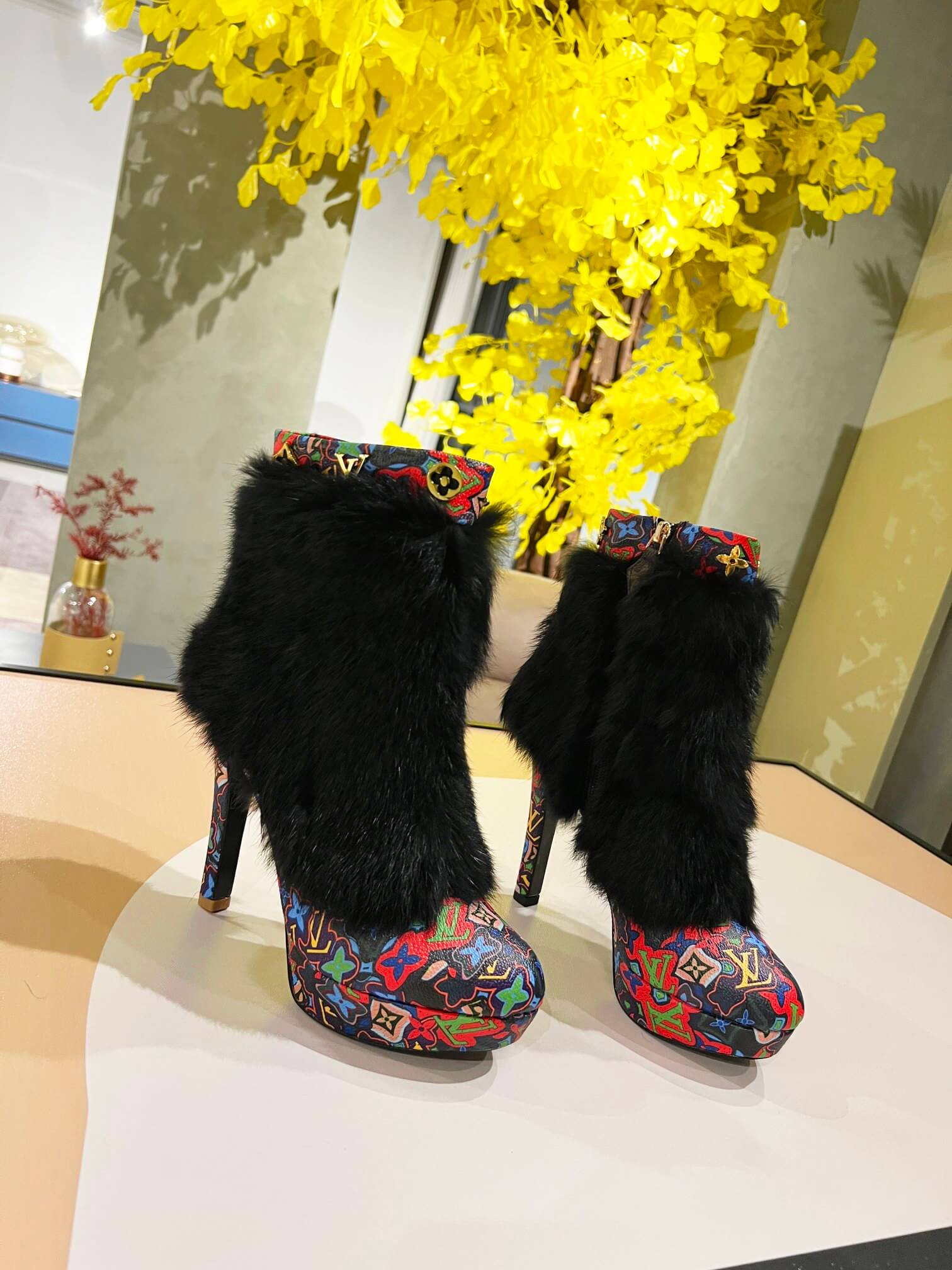 a pair of Louis Vuitton Winter Women Fluffy Faux Fox Fur Ankle Boots In multi-colored Monogram pattern