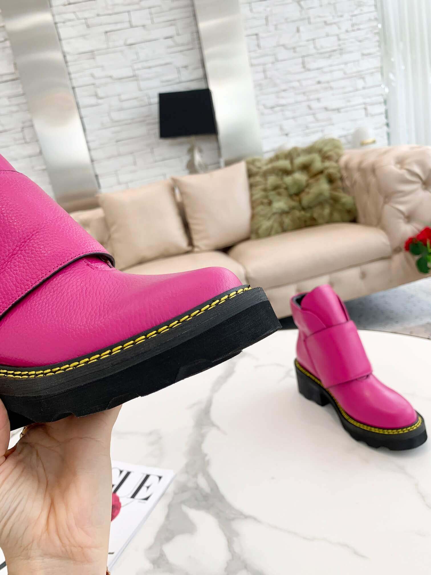 a pair of Louis Vuitton Wonderland Flat Ranger Boots in Pink Leather on a table