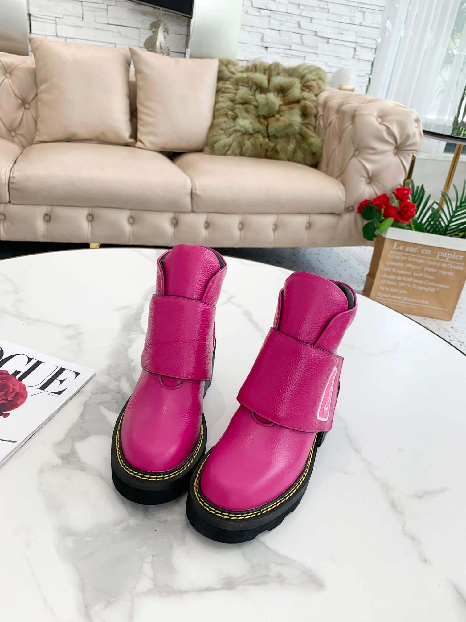 a pair of Louis Vuitton Wonderland Flat Ranger Boots in Pink Leather on a table