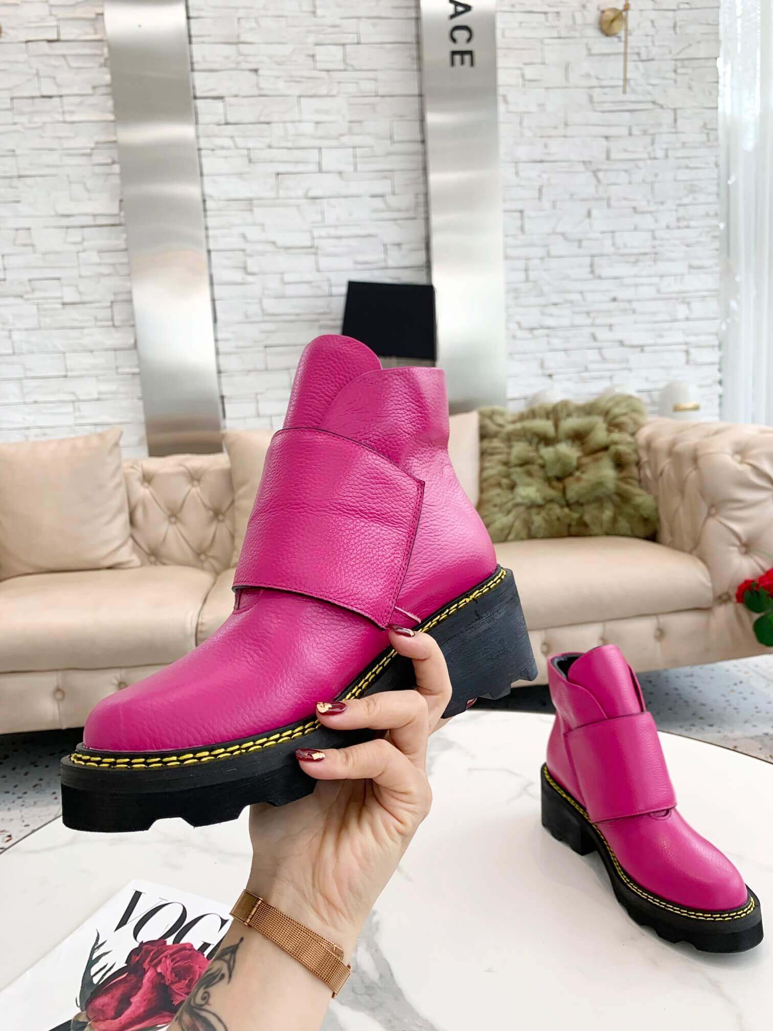 a pair of Louis Vuitton Wonderland Flat Ranger Boots in Pink Leather on a table