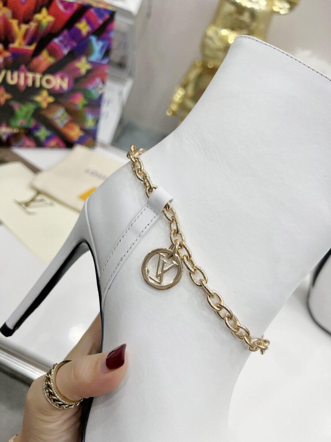 a pair of Louis Vuitton Mansion Chain Ankle Boots In White