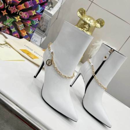 a pair of Louis Vuitton Mansion Chain Ankle Boots In White