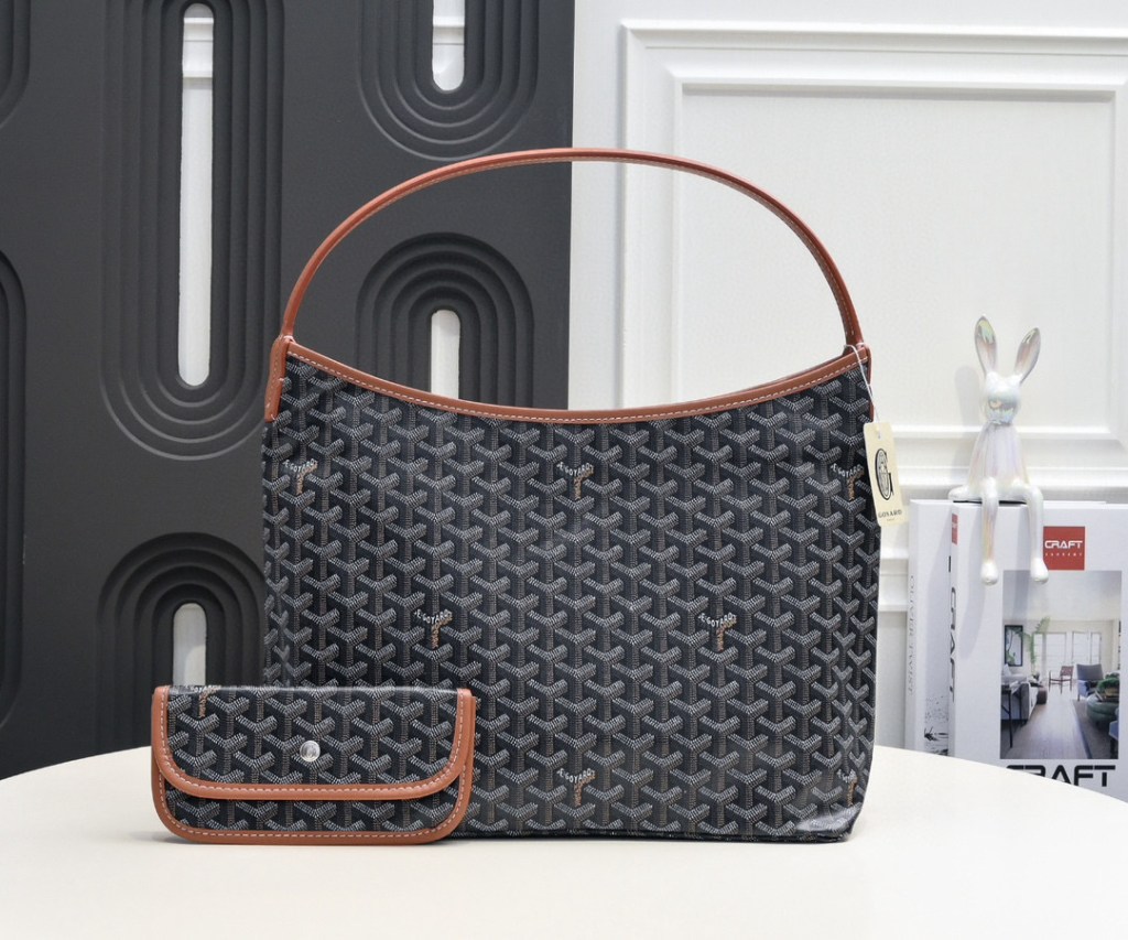 Black Goyard Bohème GM Hobo Bag in Goyardine coated canvas with tan Chevroches calfskin trim, featuring a single shoulder strap, zip-top closure, and matching removable pouch, photographed from multiple angles.