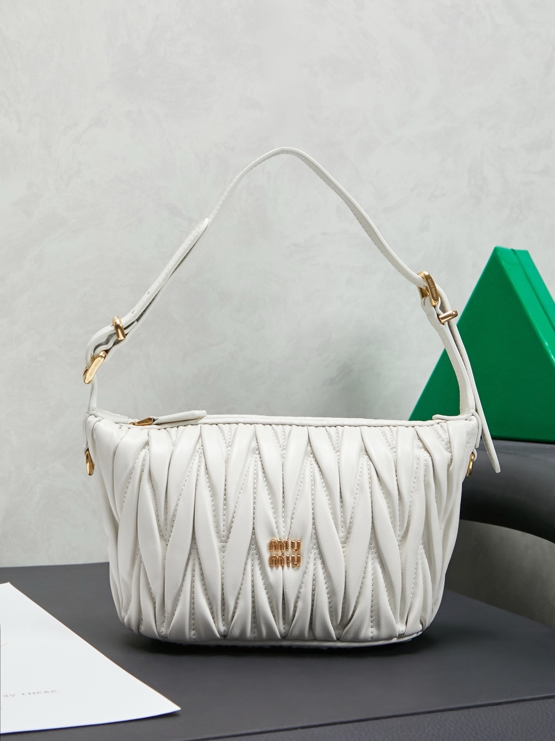 Miu Miu White Matelassé Leather Mini Shoulder Bag with gold-tone hardware and adjustable strap.