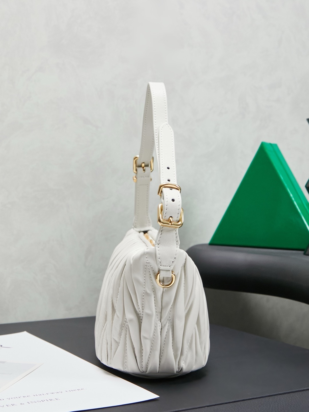 Miu Miu White Matelassé Leather Mini Shoulder Bag with gold-tone hardware and adjustable strap.
