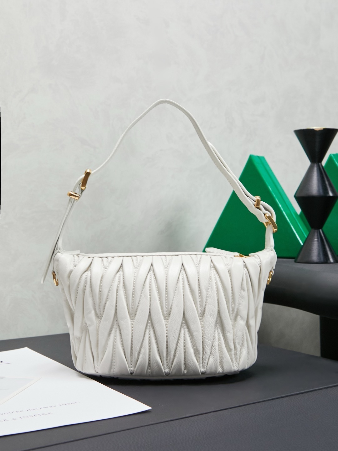 Miu Miu White Matelassé Leather Mini Shoulder Bag with gold-tone hardware and adjustable strap.