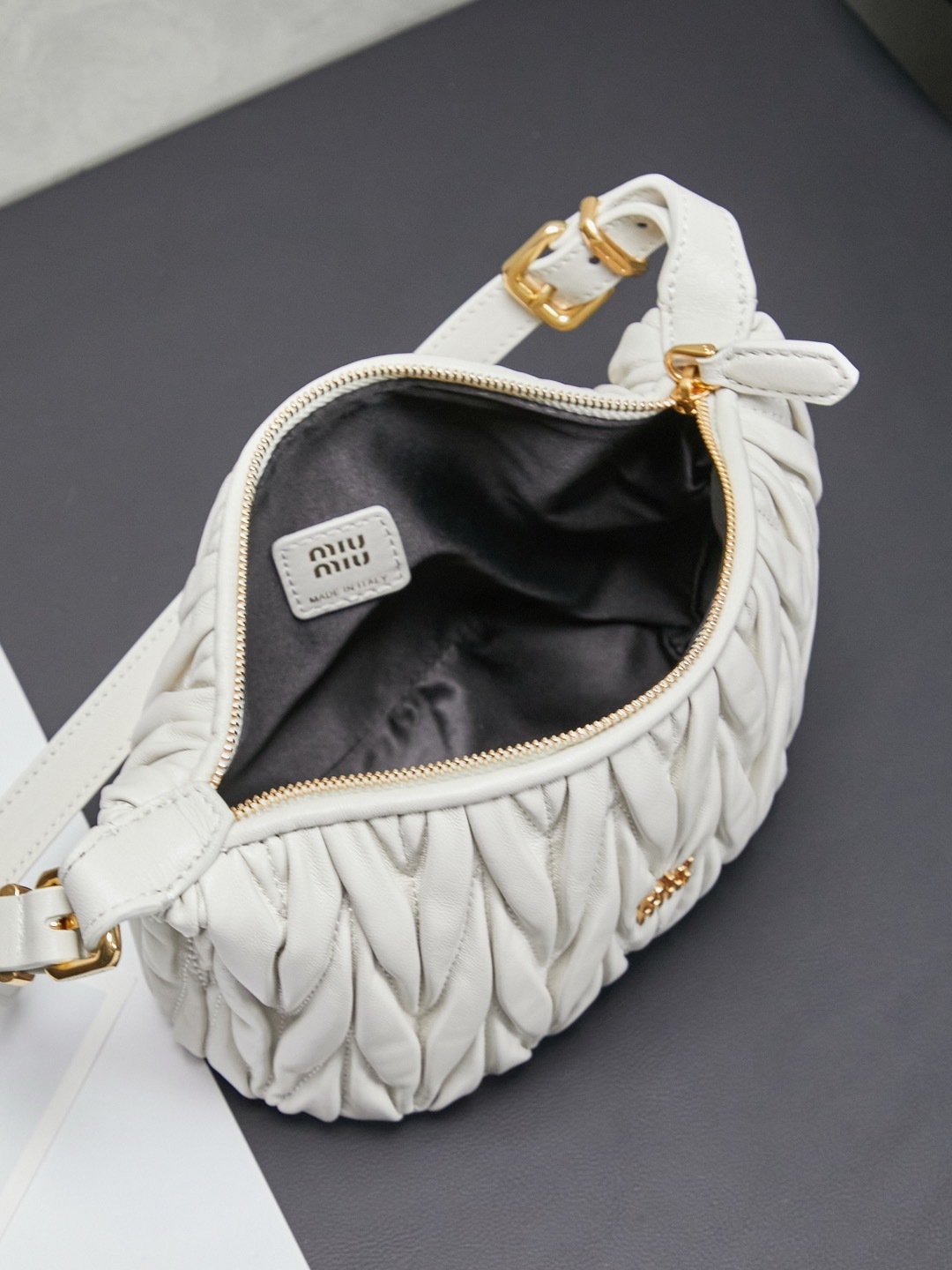 Miu Miu White Matelassé Leather Mini Shoulder Bag with gold-tone hardware and adjustable strap.