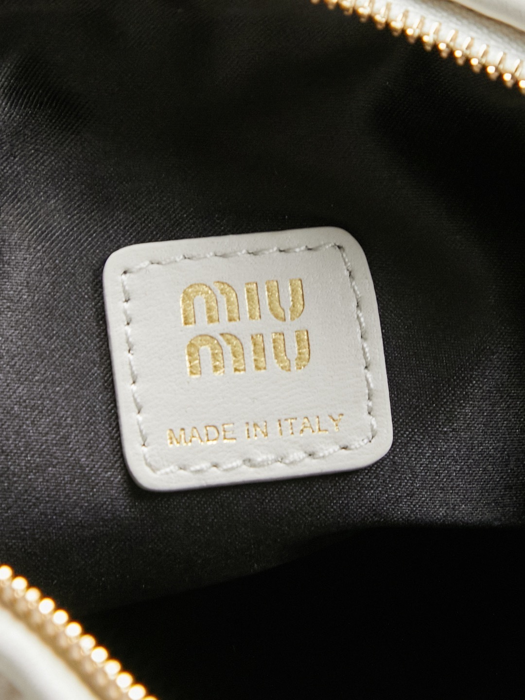 Miu Miu White Matelassé Leather Mini Shoulder Bag with gold-tone hardware and adjustable strap.