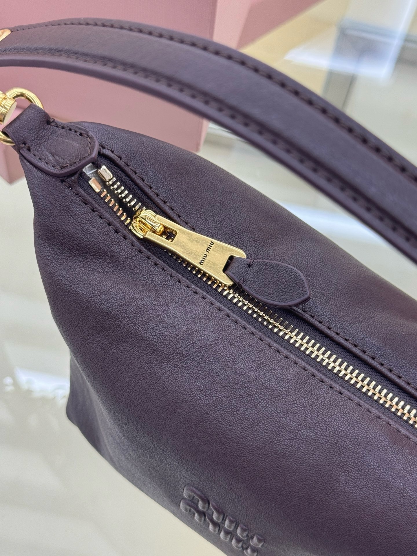 Miu Miu dark brown leather paddle shoulder bag front view in pink box