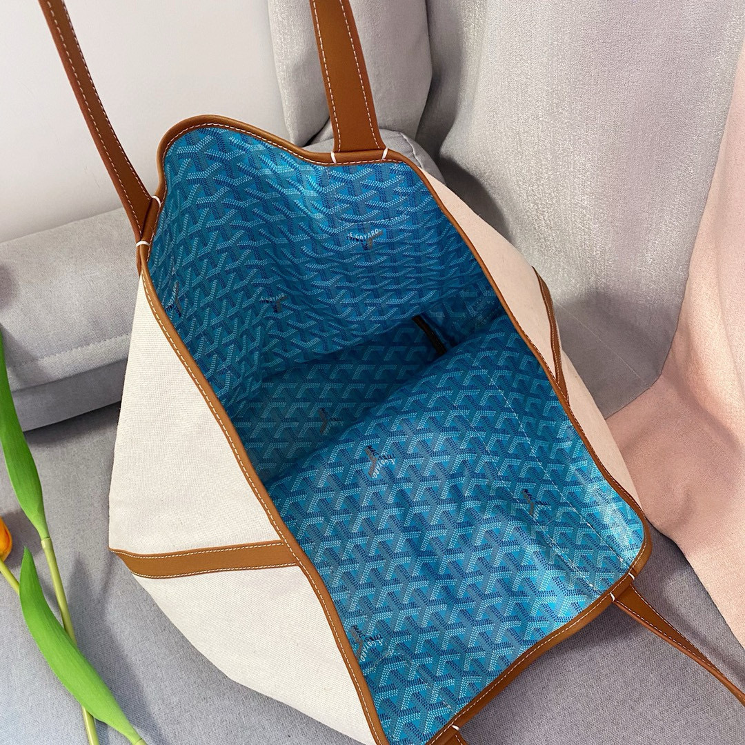 Goyard Belharra Tote in natural canvas with blue Goyardine bands and tan leather handles.
