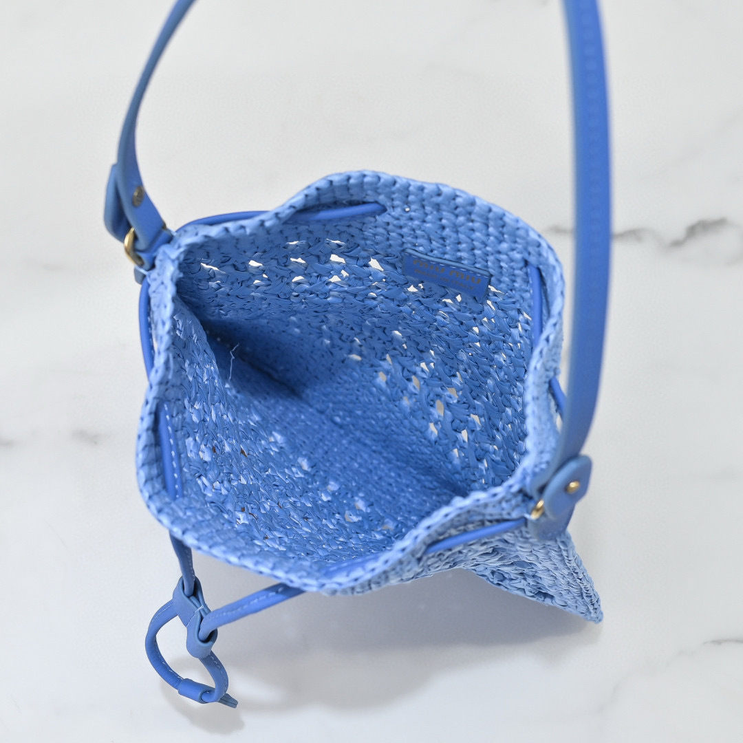Miu Miu Blue Raffia-Effect Woven Mini Bag with brown logo, leather strap, and drawstring closure, size 20 x 23 cm.