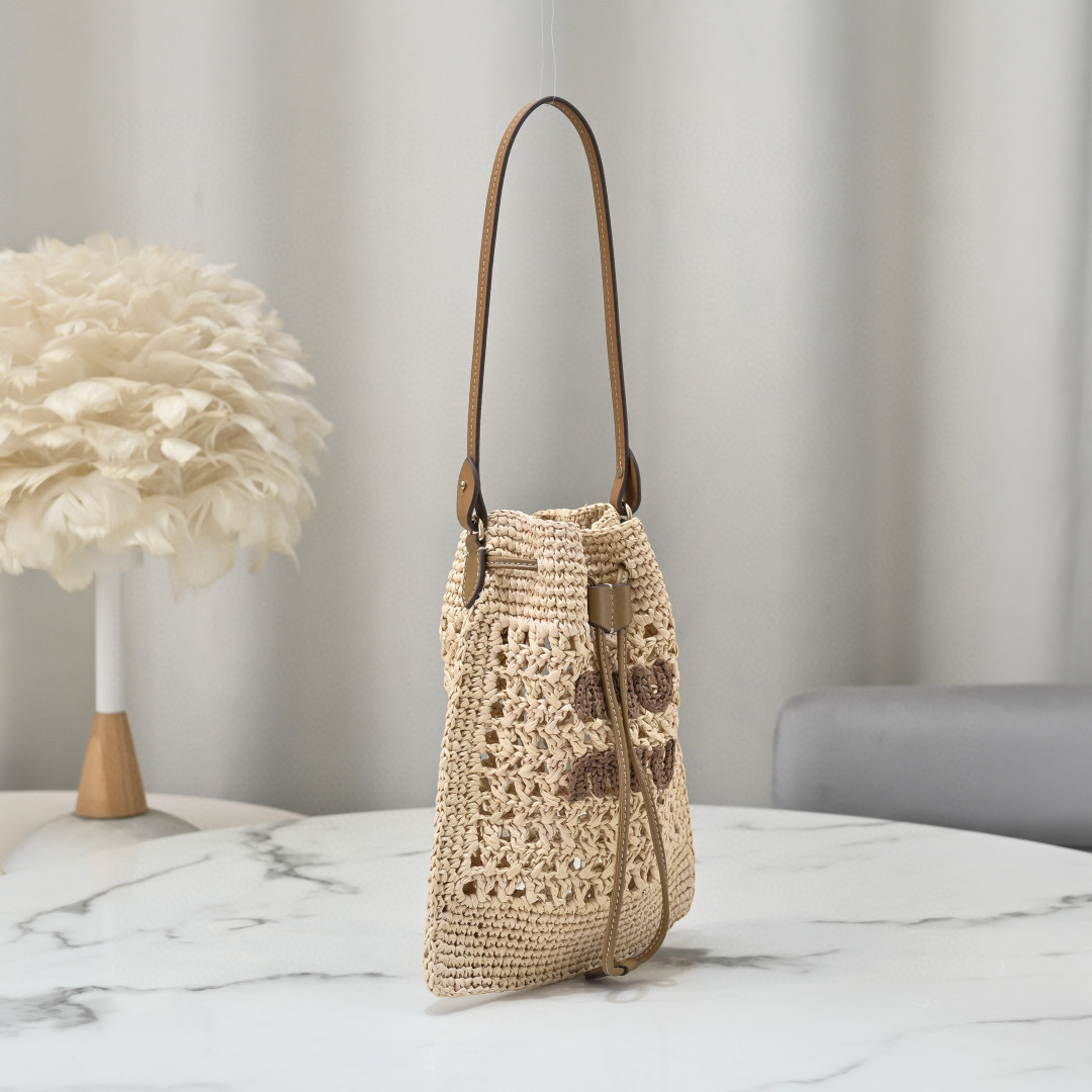 Miu Miu Natural Raffia-Effect Woven Mini Bag with brown logo, leather strap, and drawstring closure, size 20 x 23 cm.