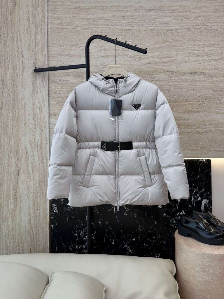 Prada Belted Puffer Women's Hooded Jacket in a light gray color.