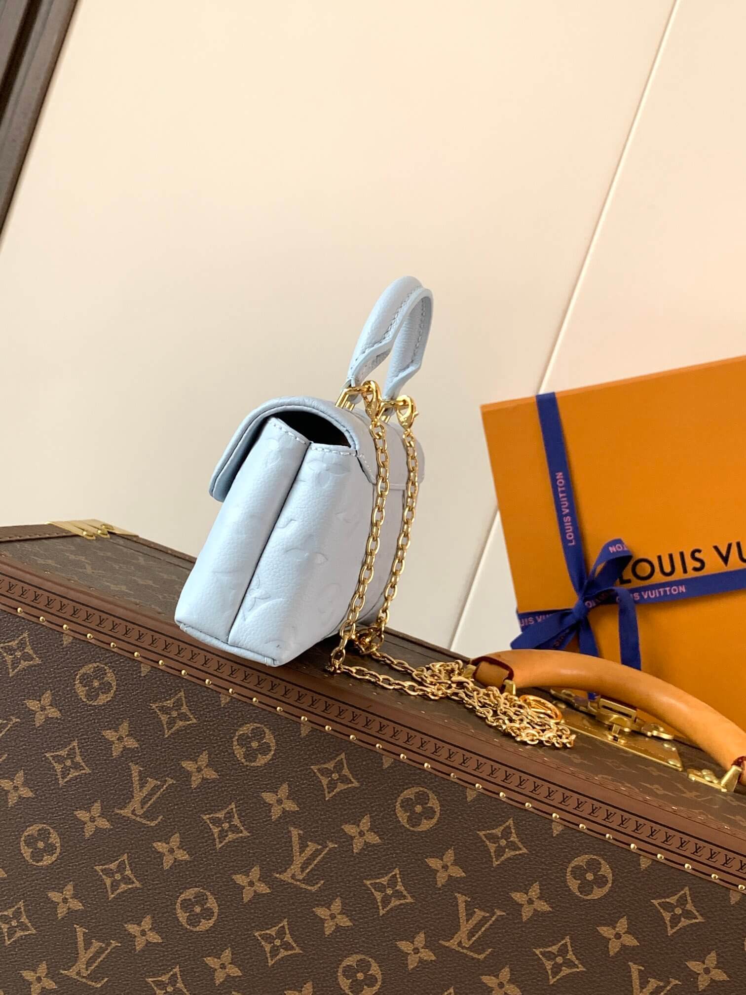 Louis Vuitton Monogram Empreinte Leather Micro Metis Light Blue Crossbody Bag with Gold Hardware and Luxury Trunk Display - Image 3