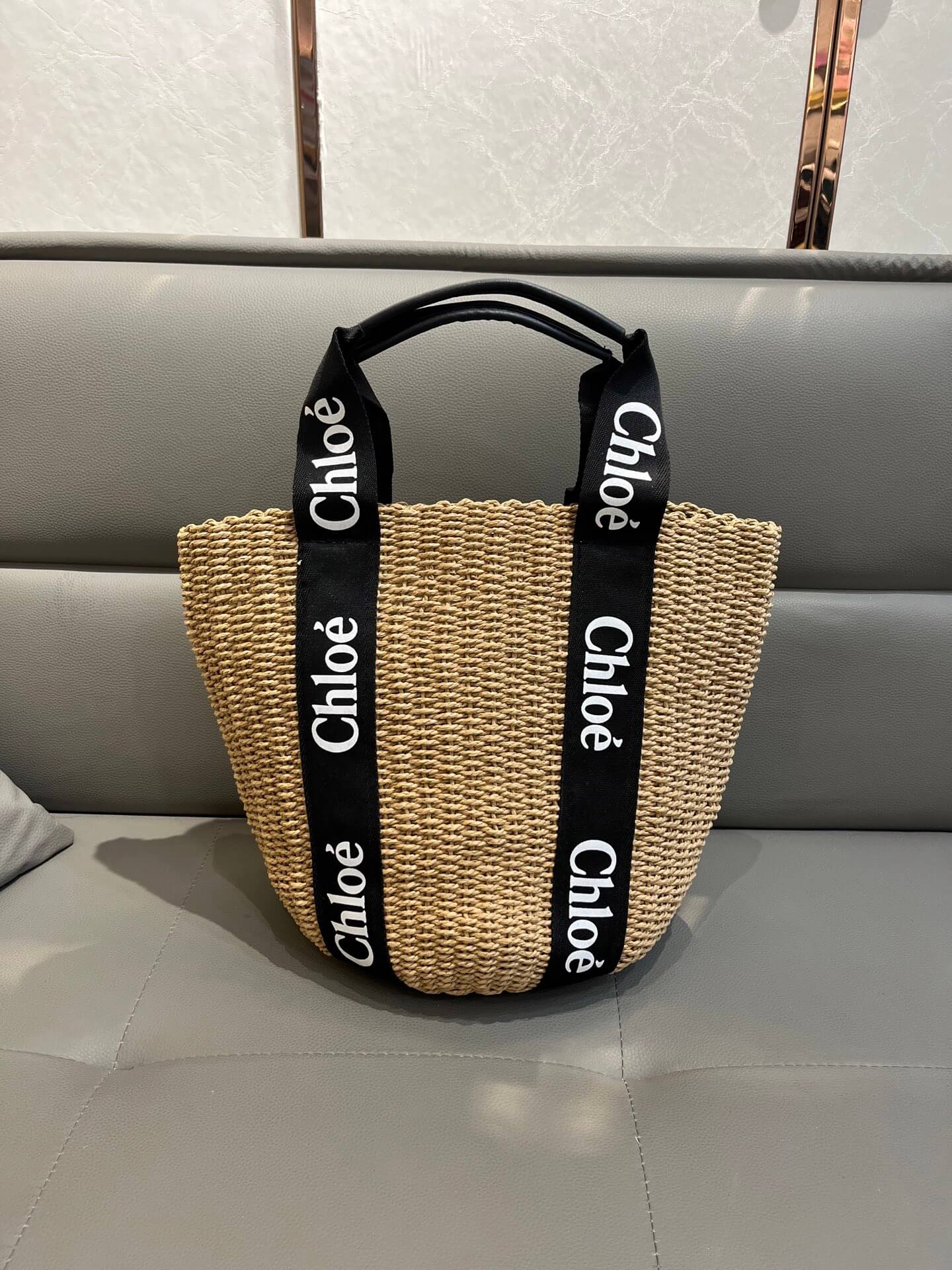 Chloé Woody Medium Basket Bag in Black Woven Straw with Logo Webbing Straps.