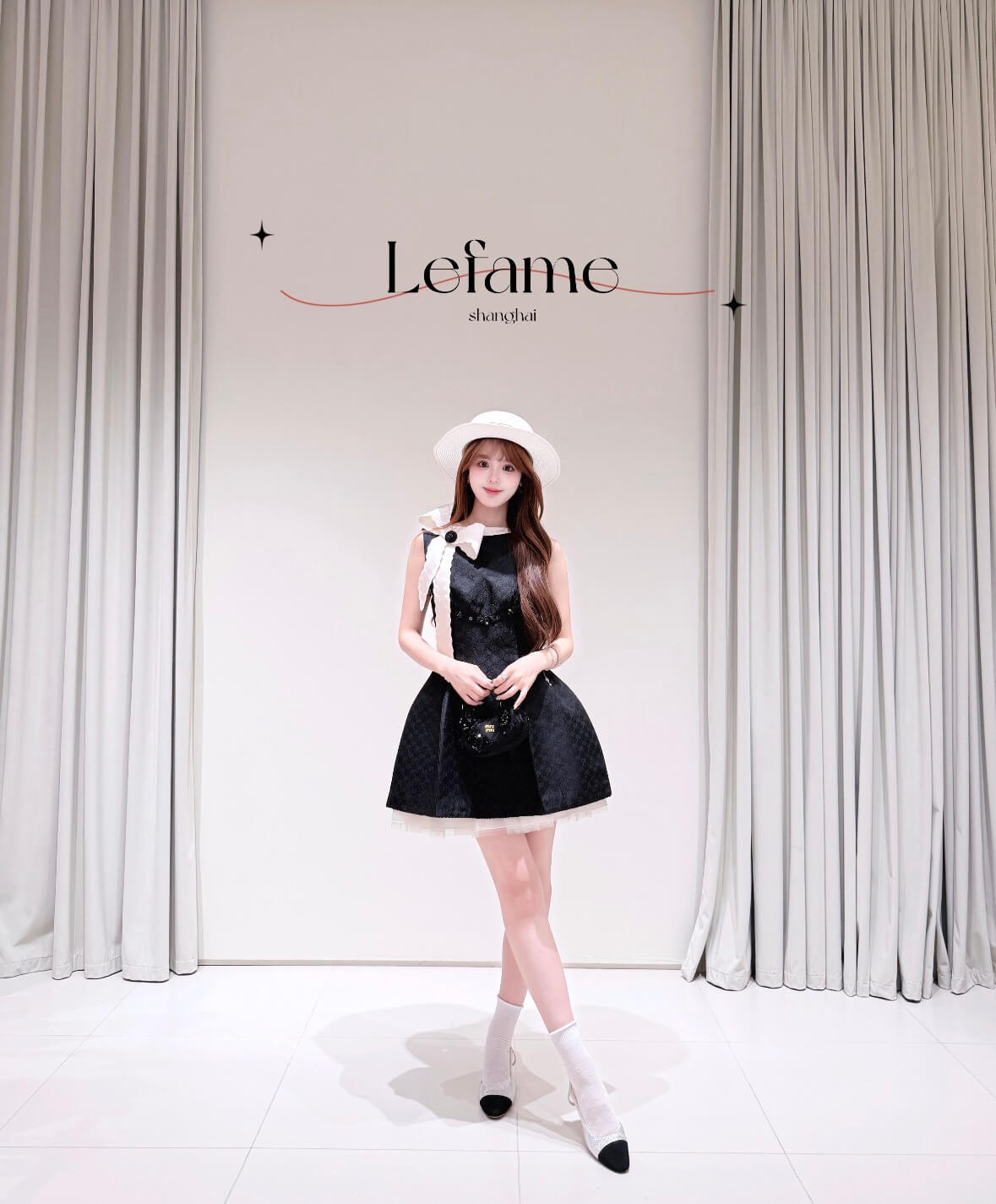 Chanel Black Sleeveless Jacquard Mini Dress with White Lace Bow.