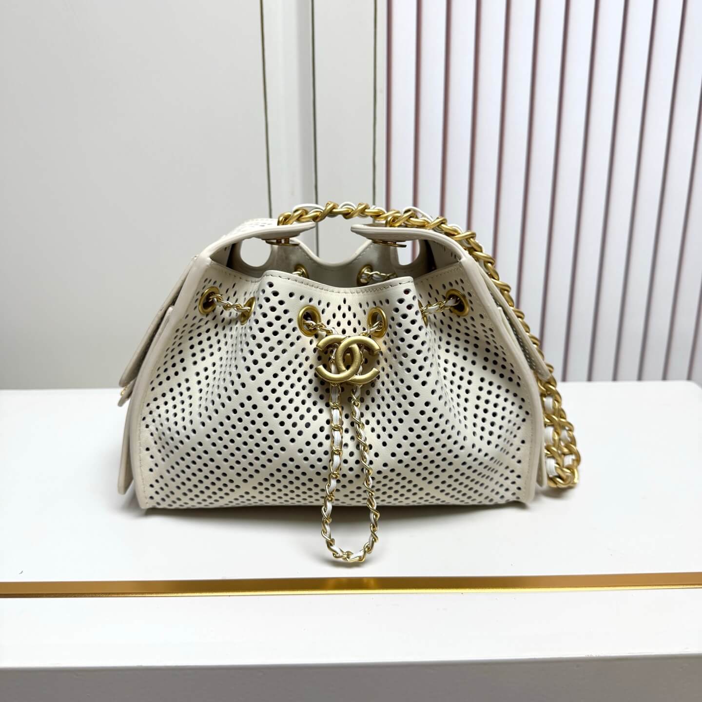 Chanel Perforated White Leather Hobo Bag with Gold-Tone Chain Hardware.