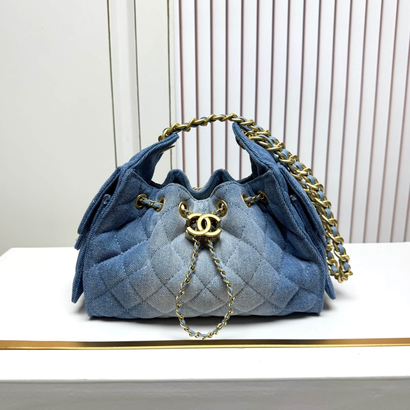 Chanel Quilted Blue Denim Hobo Bag with Gold-Tone Chain Hardware.