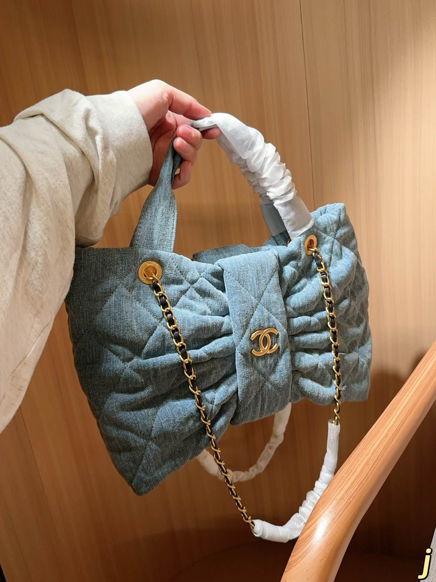 Chanel Quilted Light Blue Denim Tote Bag with Gold-Tone Chain Hardware.