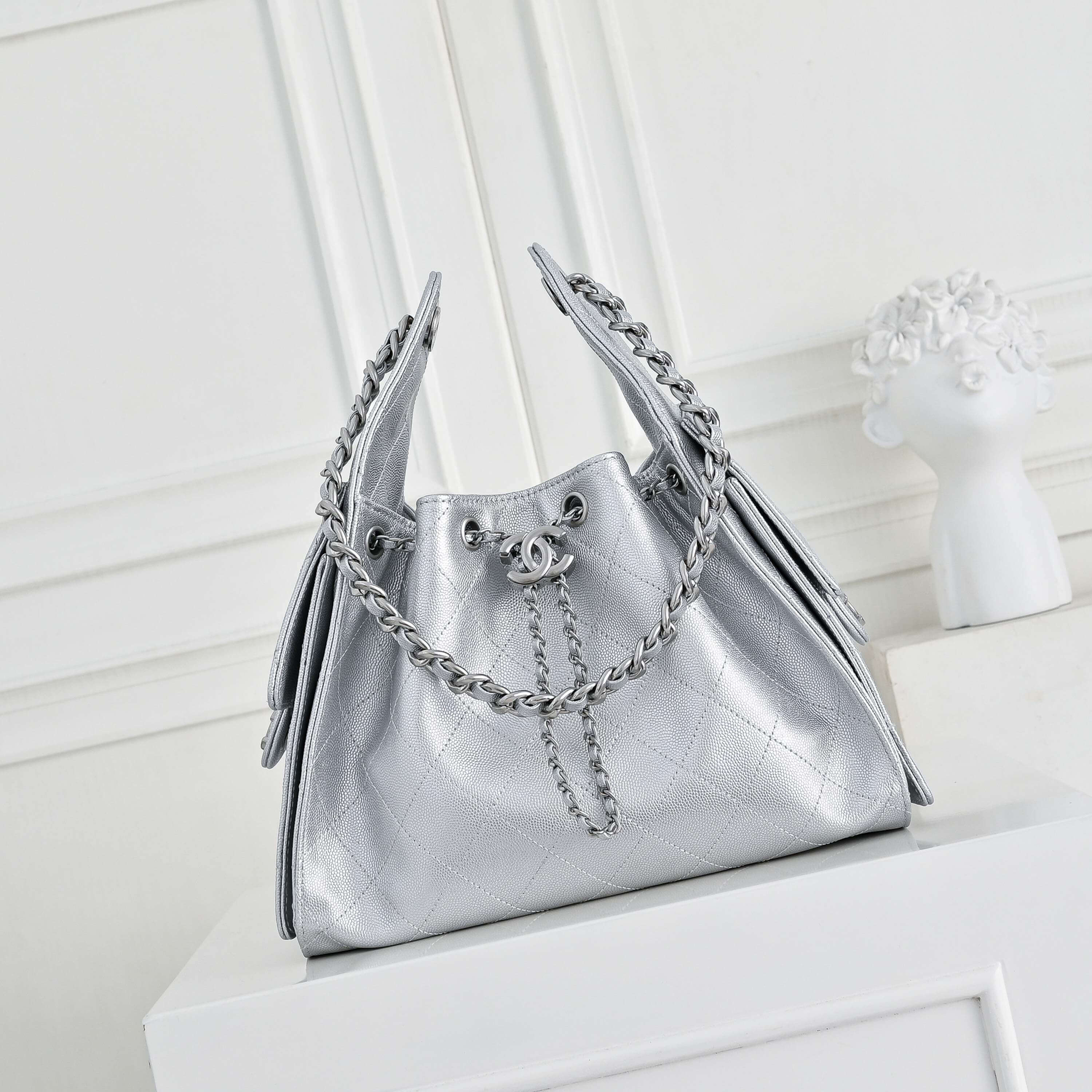 Chanel Quilted Metallic Silver Leather Hobo Bag with Silver-Tone Chain Hardware.