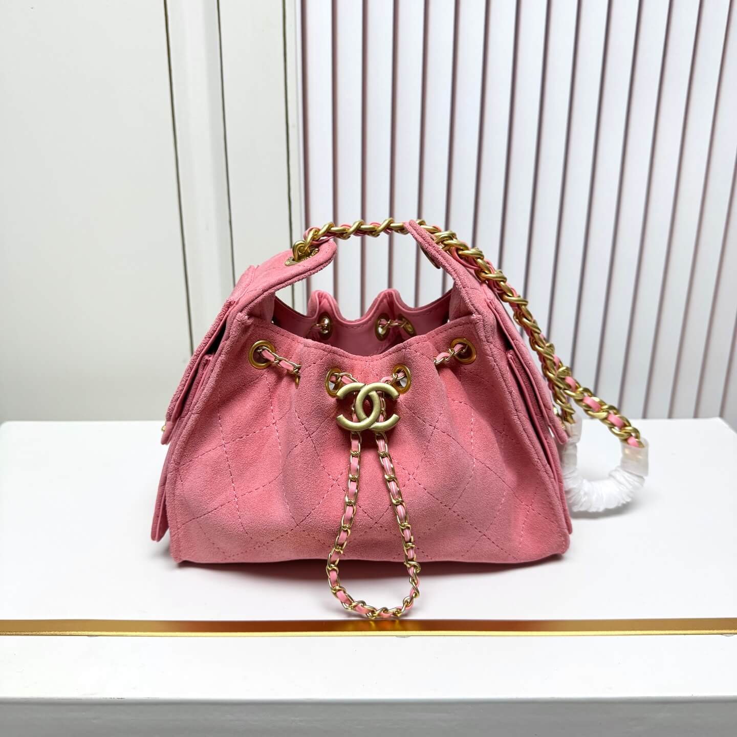 Chanel Quilted Pink Suede Hobo Bag with Gold-Tone Chain Hardware.
